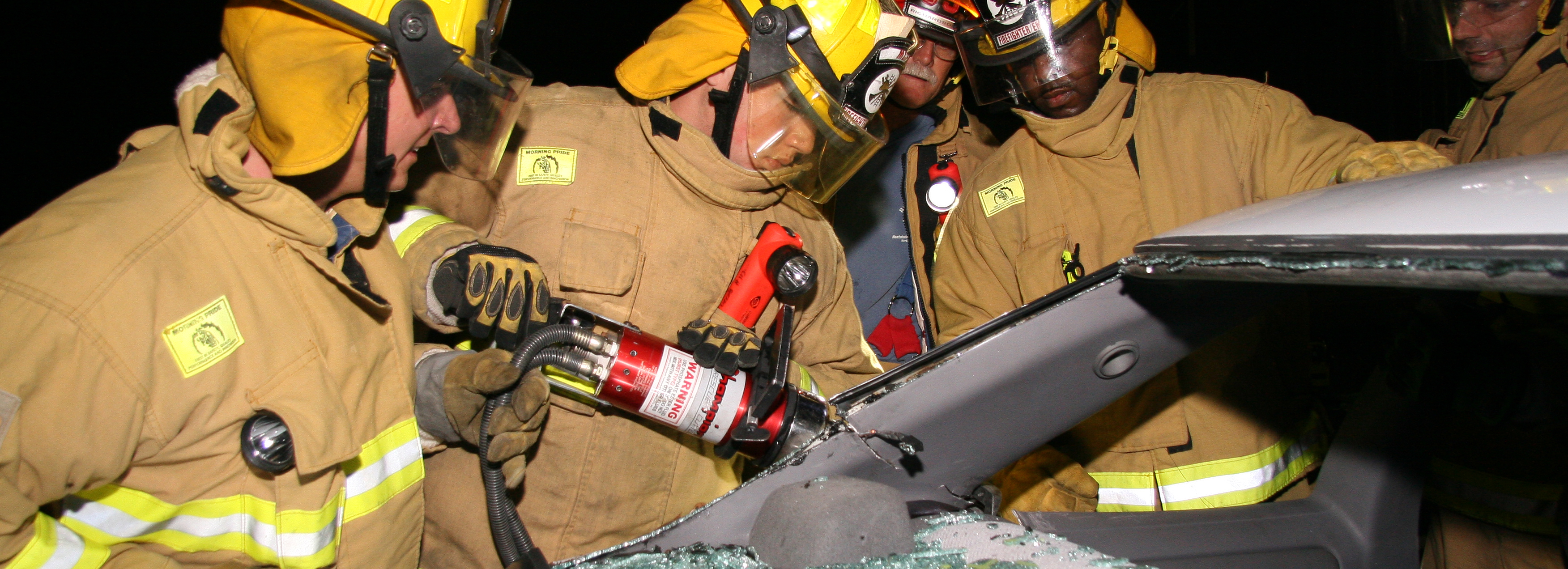 Fire students using tools to access car