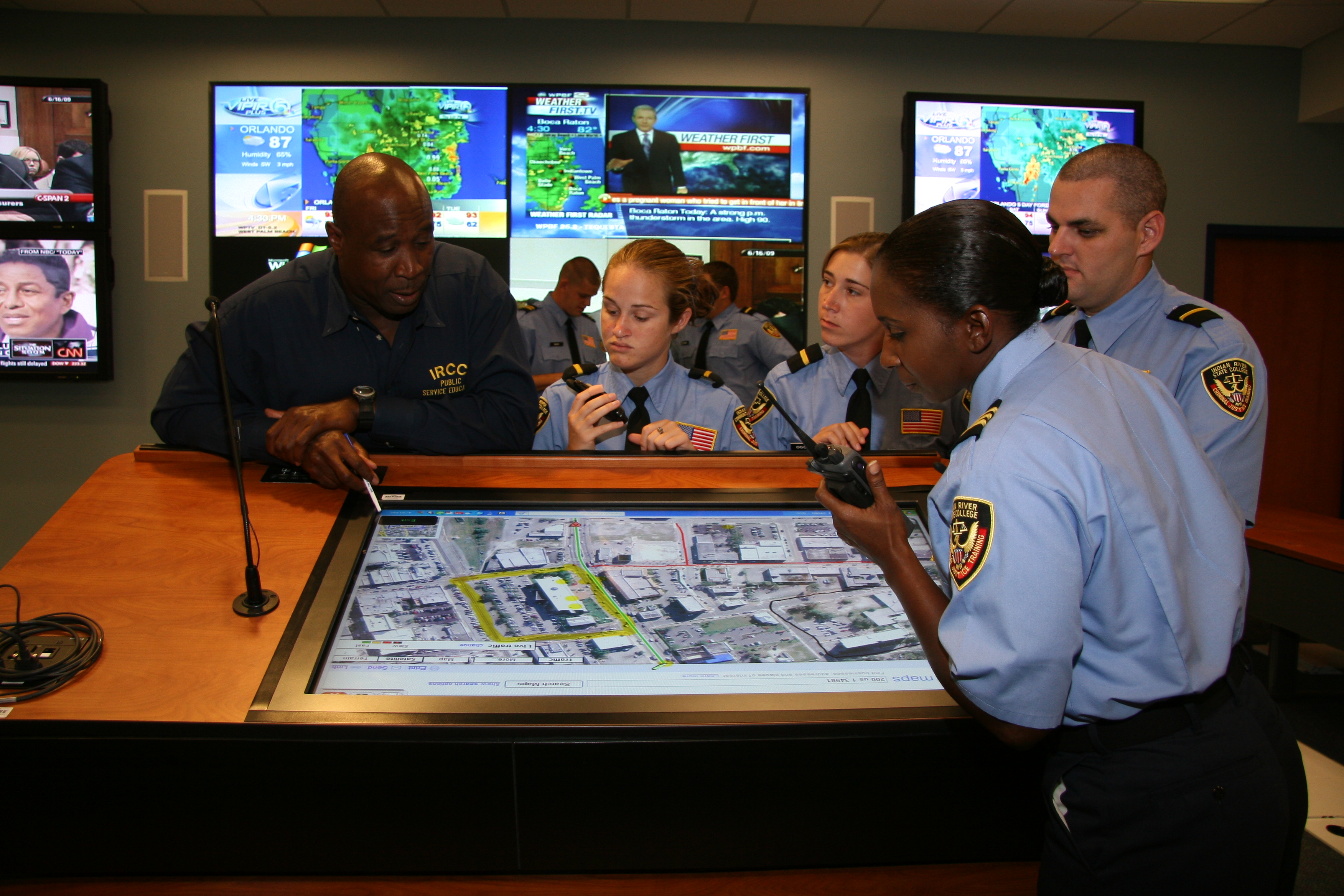 Students looking over screen in Emergency Operations Center