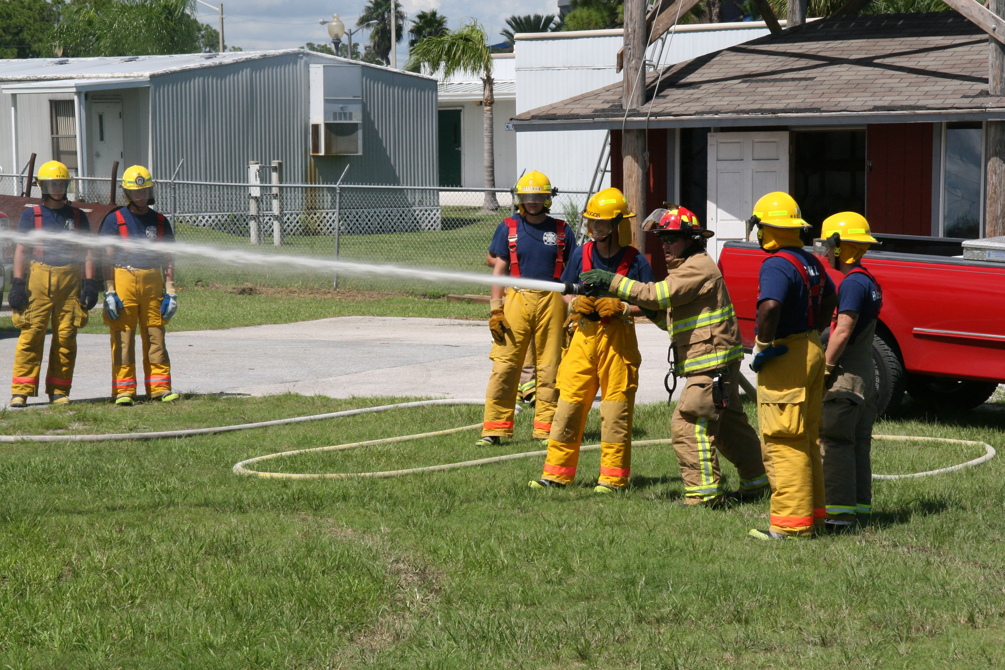 Fire students learning how to use fire hose