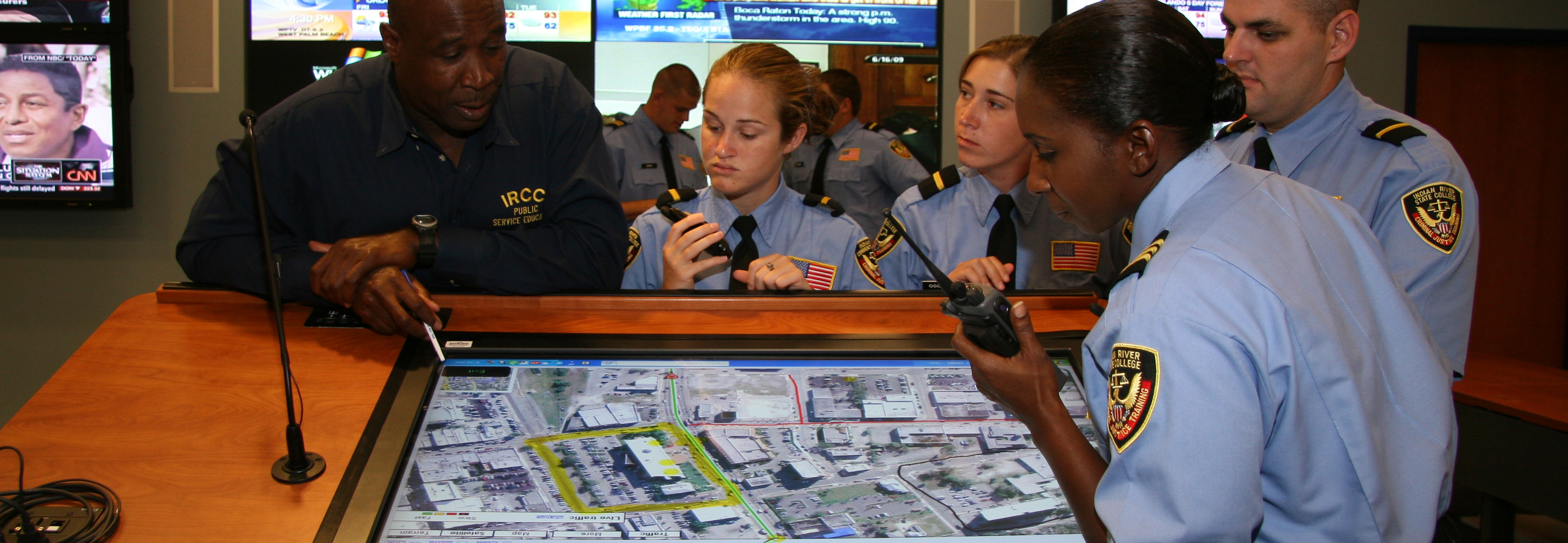 Students looking over screens in the Emergency Operations Center